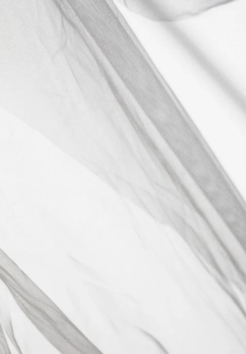 Sheer white fabric in soft folds